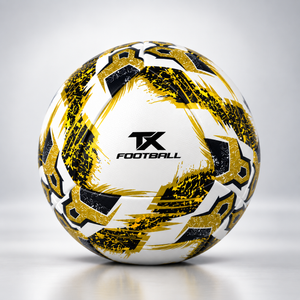 A Hybrid soccer ball with a black and gold geometric pattern and the TX FOOTBALL logo in the center, set against a light gray studio background.
